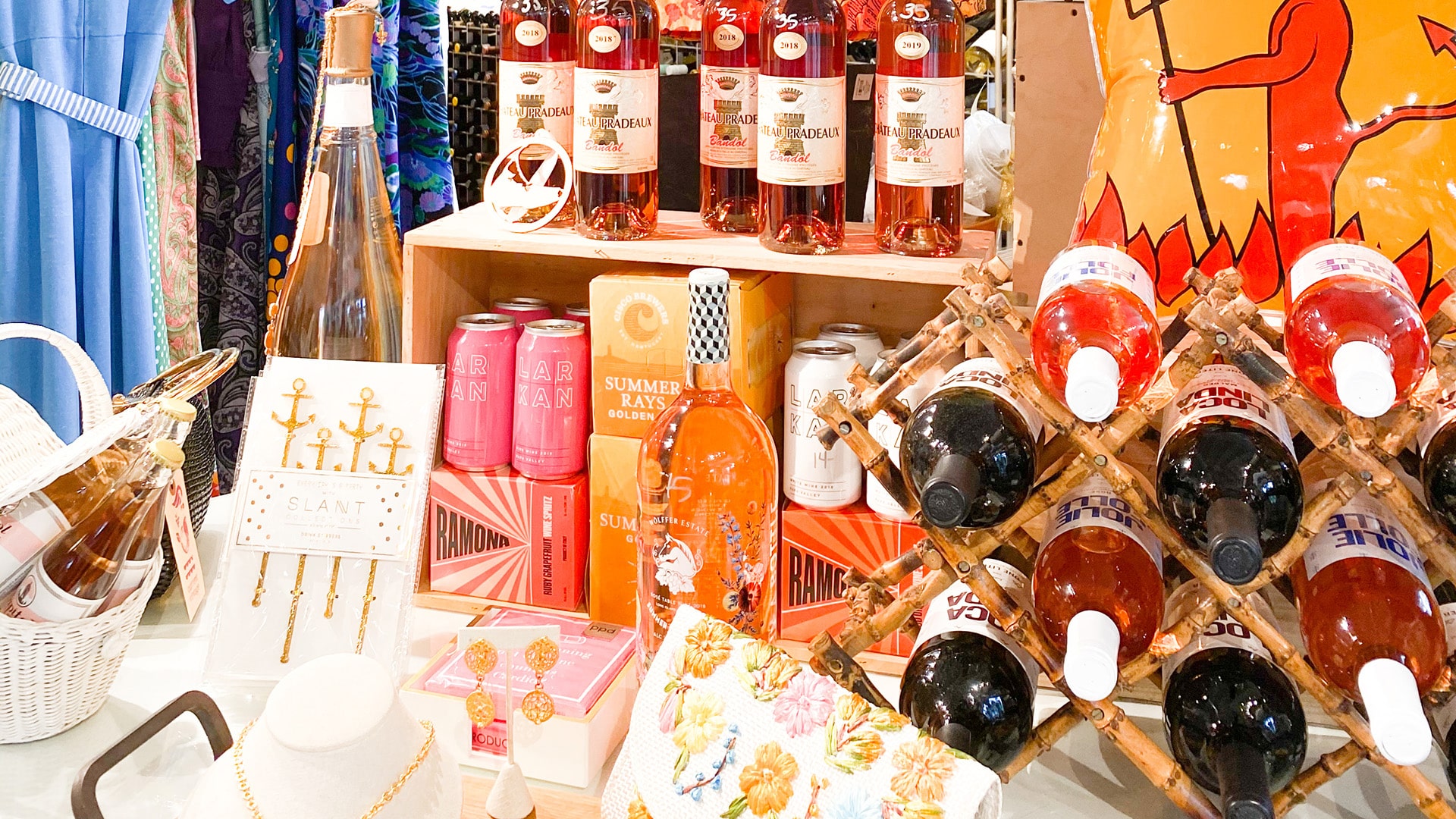 a table of wine bottles, jewelry and colorful gifts