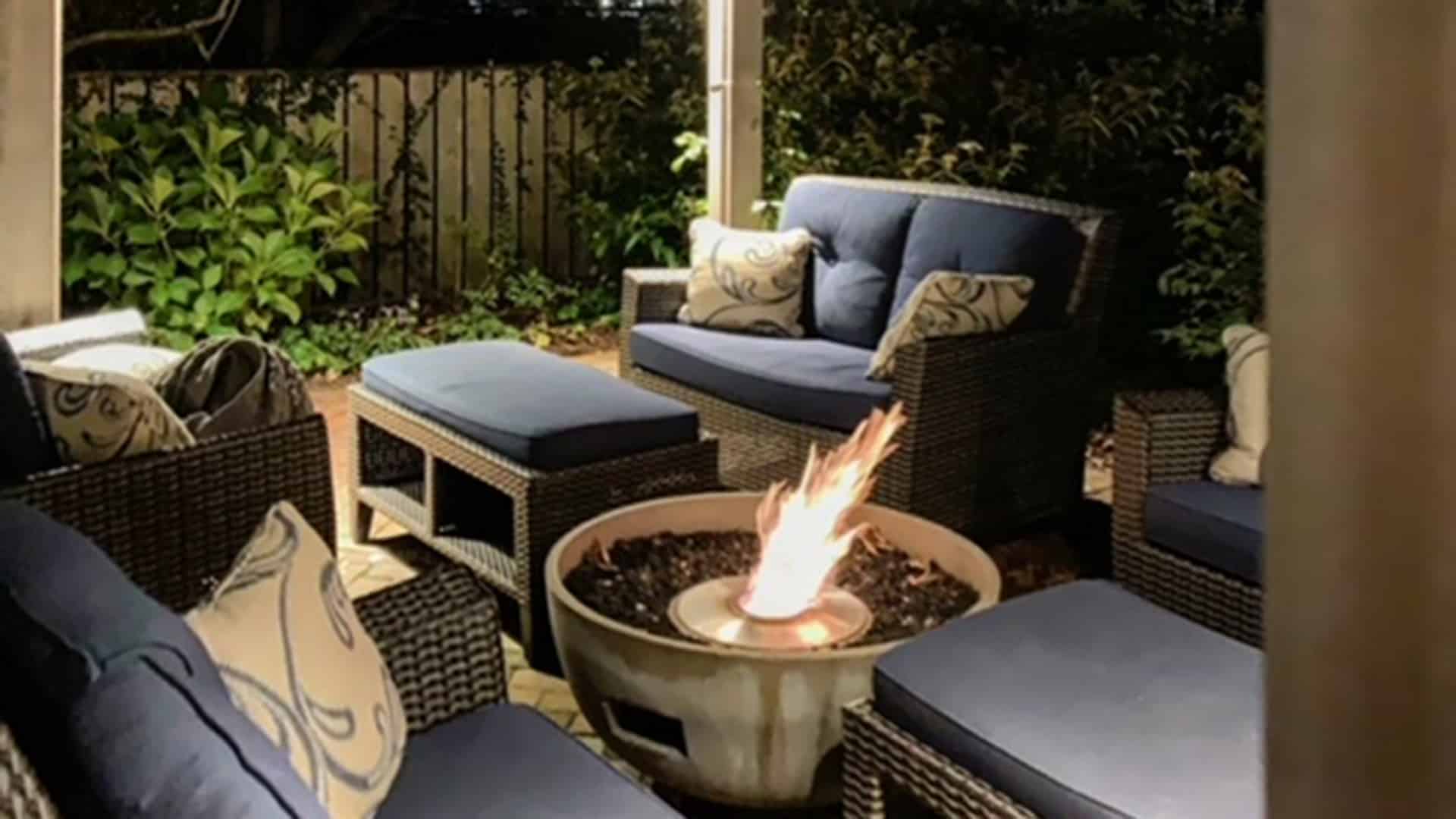 a blue couch and a fire pit in the dark