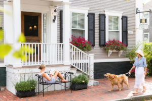 Women and her dog walking to Brass Lantern and women sitting on the bench.