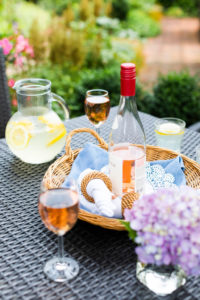 Outside Patio-display of lemonade in glass jug, wine bottle in basket, glasses of wine and spring of hydrangea