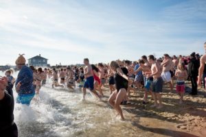 People running into the frigid Nantucket waters on Thanksgiving Day for a fundraiser. 