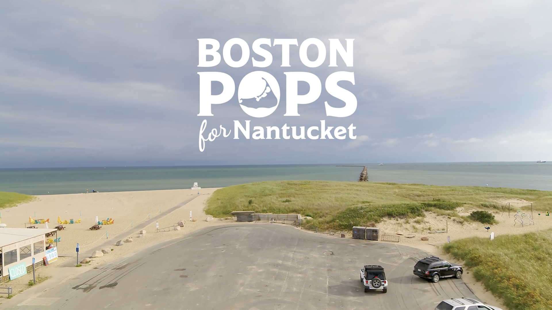 boston pops for nantucket in white letters on top of a photos of the ocean, parking lot with three cars