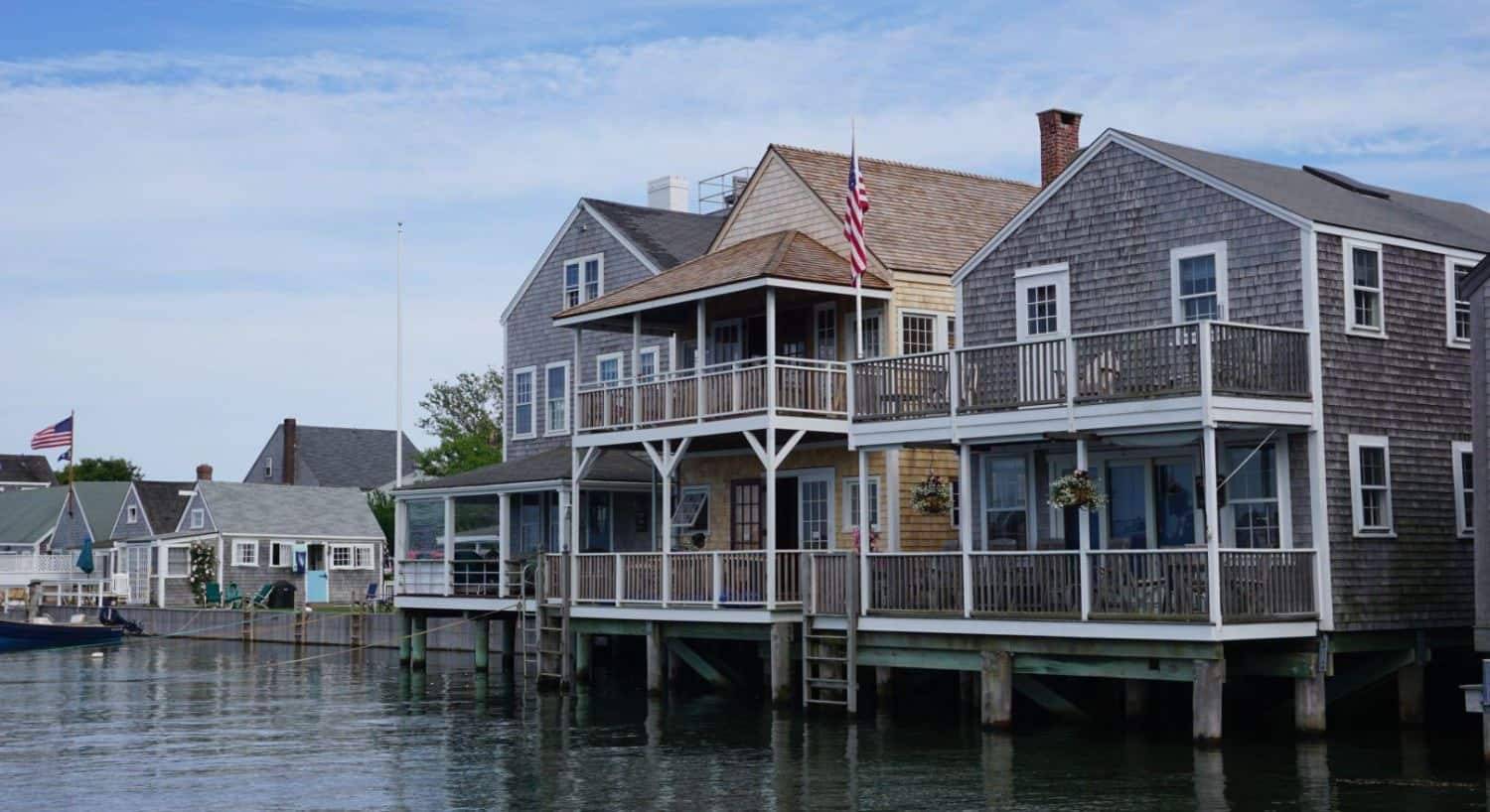 Traditional New England homes with cedar shake siding and white trim right on the water