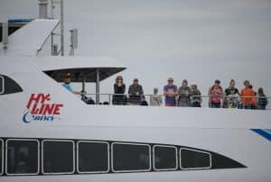 Close up view of a ferry boat with passengers standing near the railing